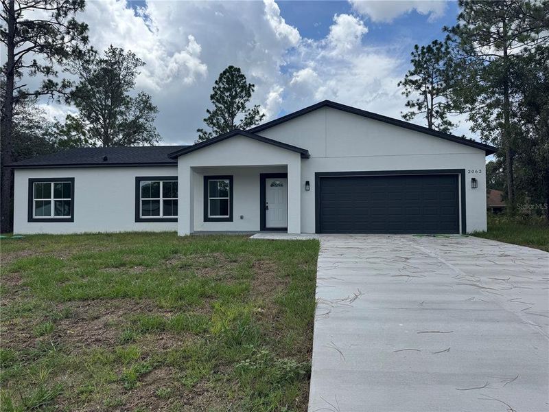 Front exterior of a new home in , Dunnellon, FL, highlighting curb appeal (Image 1).
