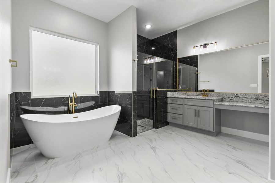 The spa like primary bath has a large soaking tub, walk-in shower, dual vanities and tons of storage. The spa like primary bath has a large soaking tub, walk-in shower, dual vanities and tons of storage.