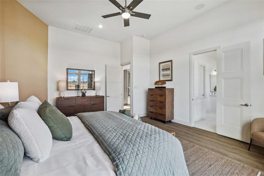 Spacious interior featuring wood-finish flooring, a contemporary ceiling fan, recessed lighting, and a neutral color palette