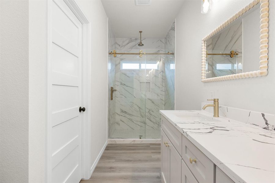 Luxurious bathroom with a spacious walk-in shower and elegant vanity. Luxurious bathroom with a spacious walk-in shower and elegant vanity.