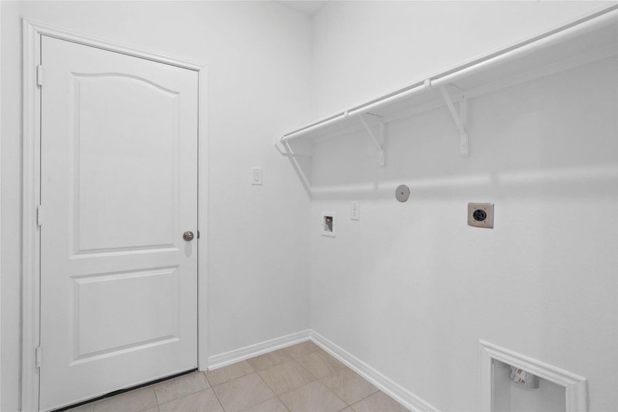 Located on the first floor is the laundry room which features a streamlined shelf that keeps all your essentials neatly within reach.