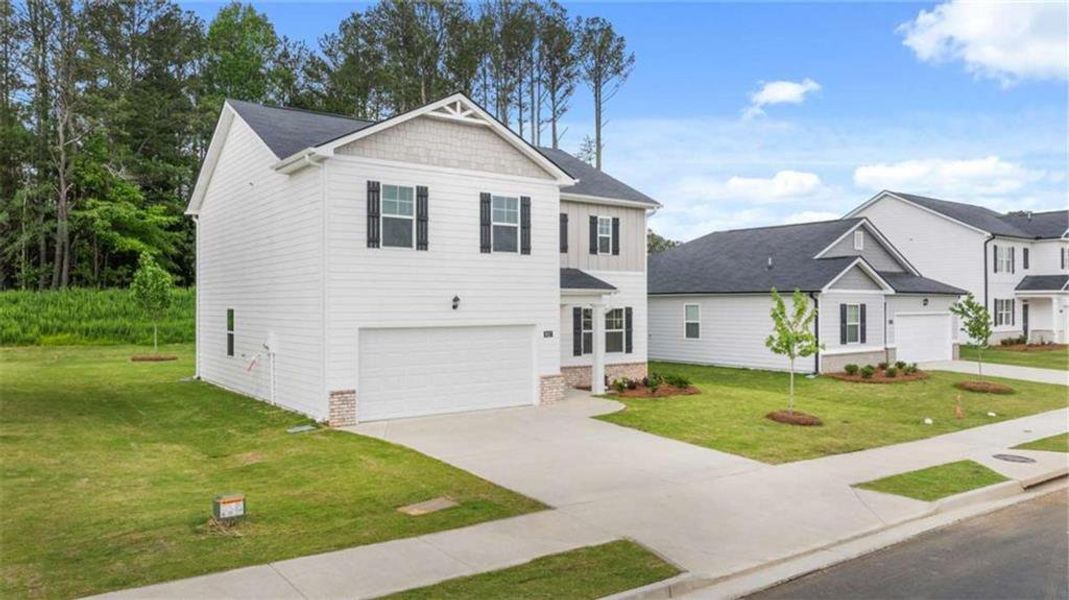 Front exterior of a new home in Poplar Preserve, Newnan, GA, highlighting curb appeal (Image 20). Front exterior of a new home in Poplar Preserve, Newnan, GA, highlighting curb appeal (Image 20).
