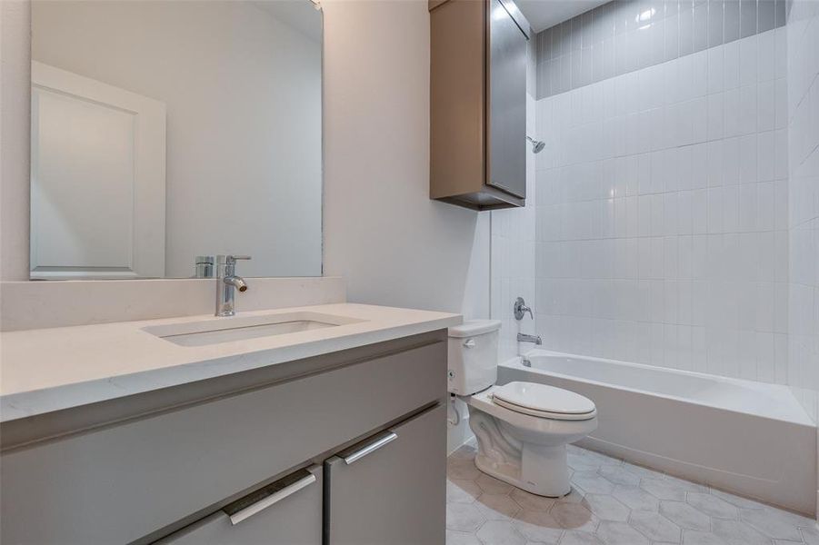 Full bathroom with shower / tub combination, tile flooring, vanity, and toilet