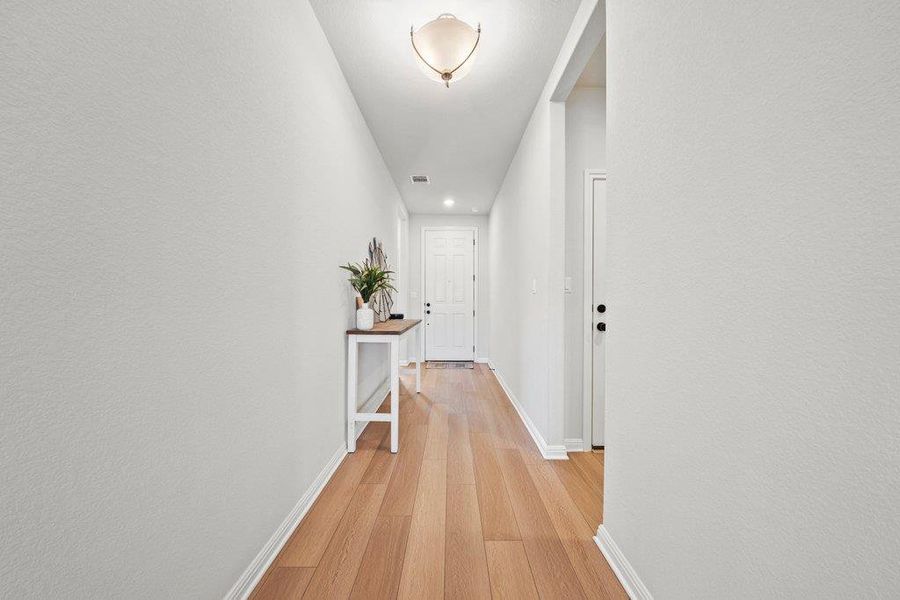 Hall featuring light wood-style flooring and recessed lighting