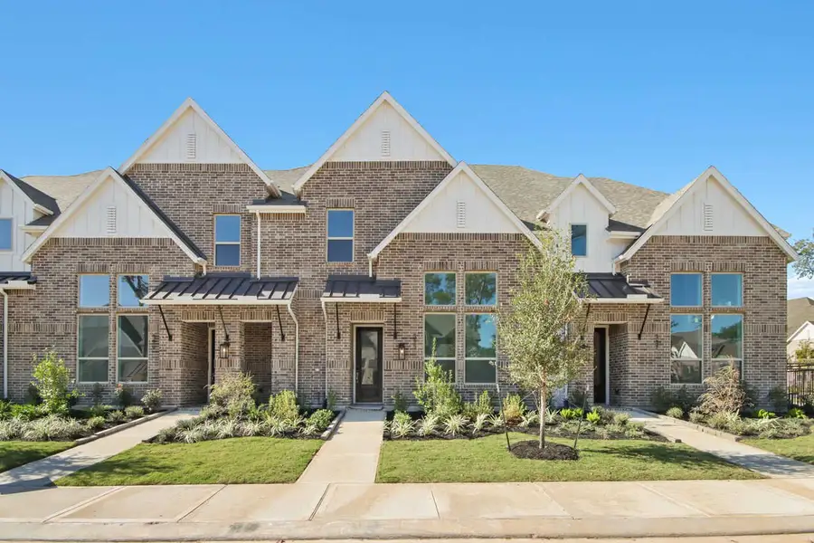 Front exterior of a new home in Woodforest Townhomes: Townhomes: The Villas, Montgomery, TX, highlighting curb appeal (Image 1). Front exterior of a new home in Woodforest Townhomes: Townhomes: The Villas, Montgomery, TX, highlighting curb appeal (Image 1).