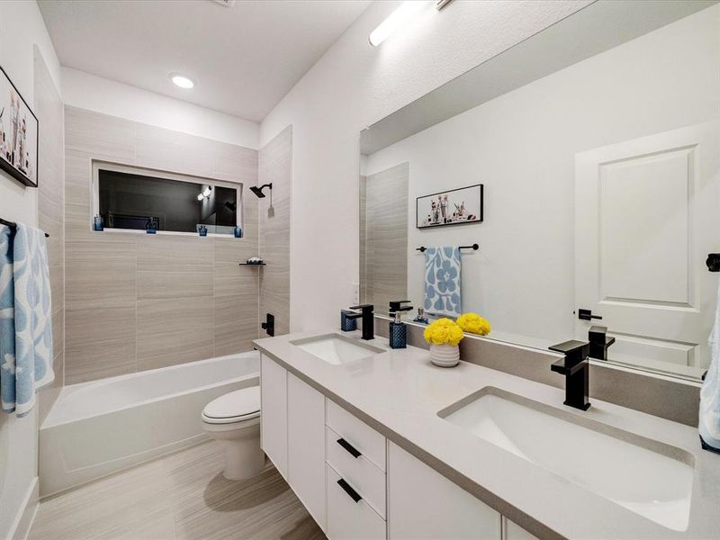 Full bath featuring bathtub / shower combination and double vanity Full bath featuring bathtub / shower combination and double vanity