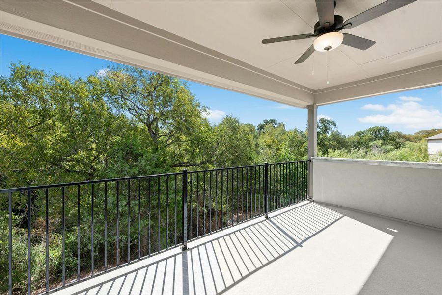 Balcony with ceiling fan, a sunroom, and view of wooded area Balcony with ceiling fan, a sunroom, and view of wooded area