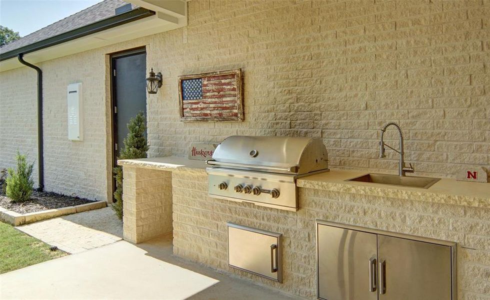 View of patio featuring sink, area for grilling, and exterior kitchen