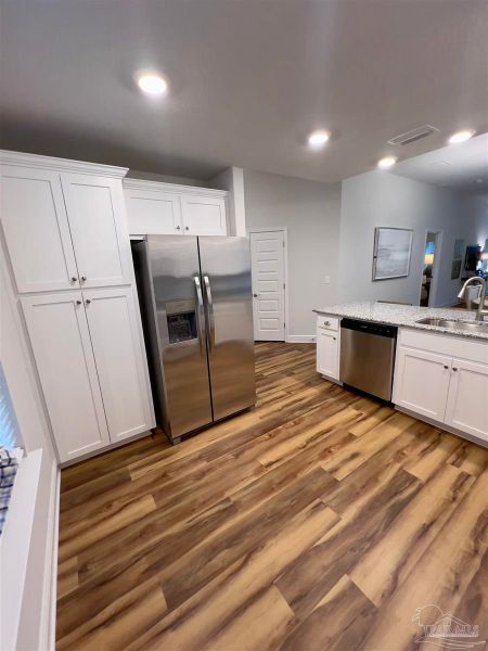 Representative furnished interior of a home built from the Plan 1454 by Adams Homes in Westpointe Place, Pensacola (Image 7).