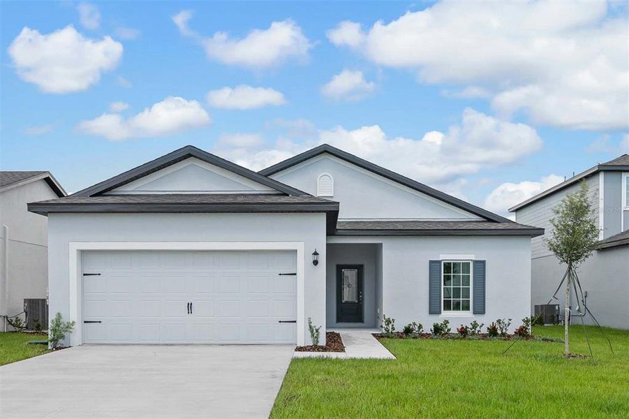 Front exterior of a new home in Tula Parc, Astatula, FL, highlighting curb appeal (Image 15). Front exterior of a new home in Tula Parc, Astatula, FL, highlighting curb appeal (Image 15).