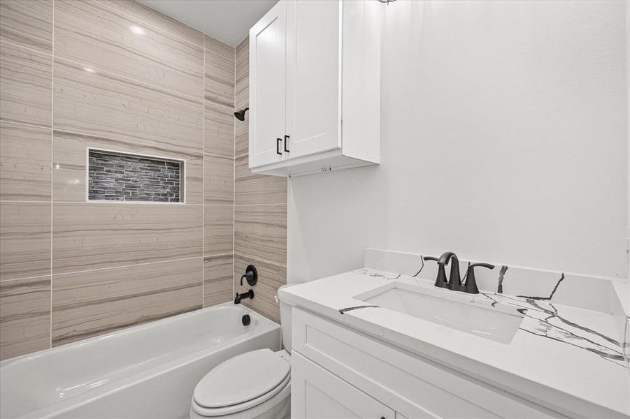 Bathroom with vanity and bathing tub / shower combination