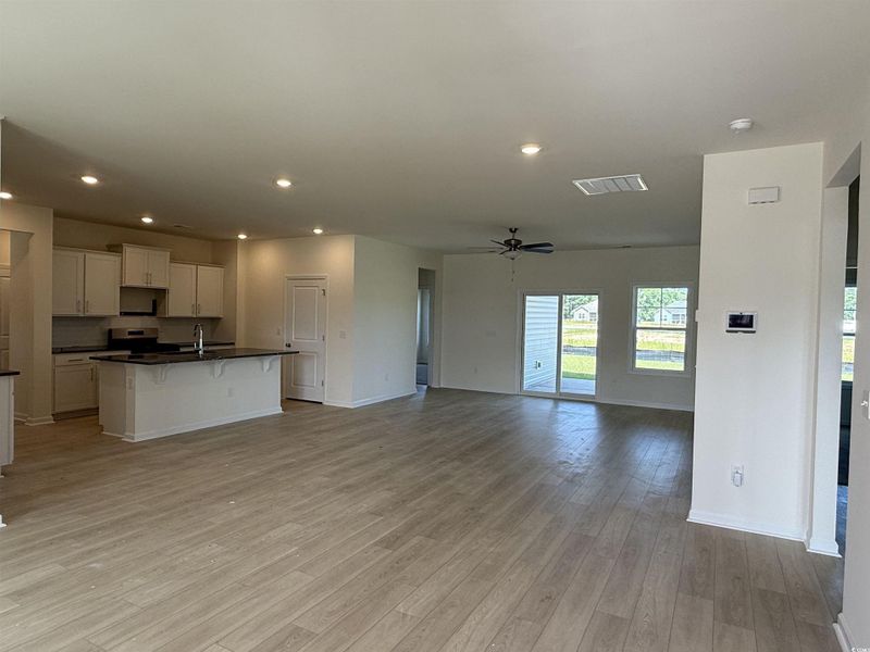 View of home's exterior featuring roof with shingles, stone siding, covered porch, and board and batten siding View of home's exterior featuring roof with shingles, stone siding, covered porch, and board and batten siding