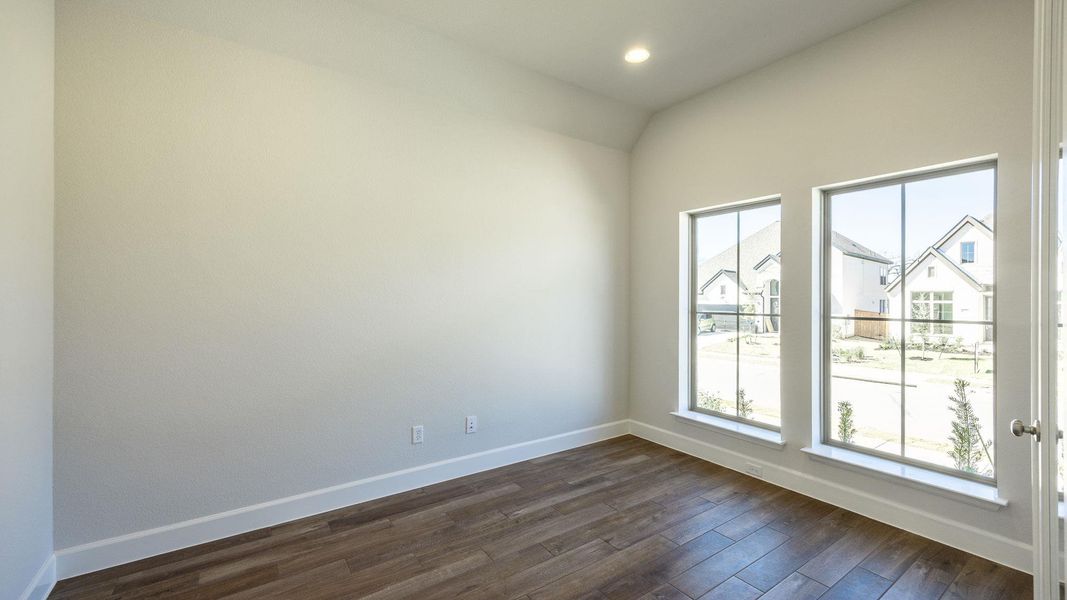 Empty room featuring recessed lighting, baseboards, plenty of natural light, and dark wood-style flooring