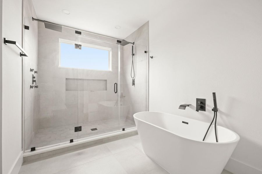 Relax after a long day in the freestanding soaking tub with waterfall faucet and a separate spray wand. Relax after a long day in the freestanding soaking tub with waterfall faucet and a separate spray wand.