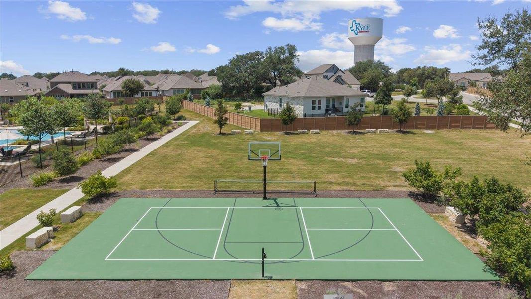 An outdoor sports court highlights the community recreation area under wide Texas skies.