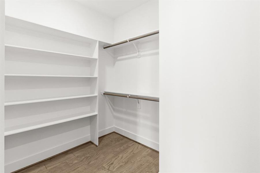 Another view of custom shelves throughout the walk in closet.