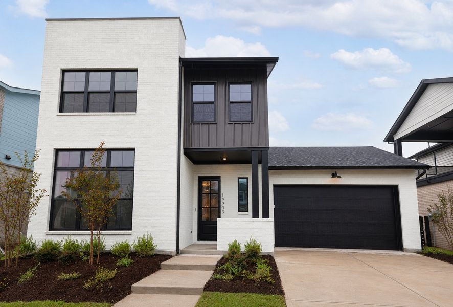 Front exterior of a new home in Easthaven at Bridgeland Central - Vision Collection, Cypress, TX, highlighting curb appeal (Image 2). Front exterior of a new home in Easthaven at Bridgeland Central - Vision Collection, Cypress, TX, highlighting curb appeal (Image 2).
