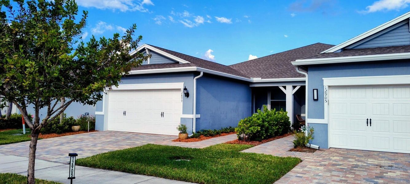 Front exterior of a new home in Del Webb Tradition, Port St. Lucie, FL, highlighting curb appeal (Image 18).