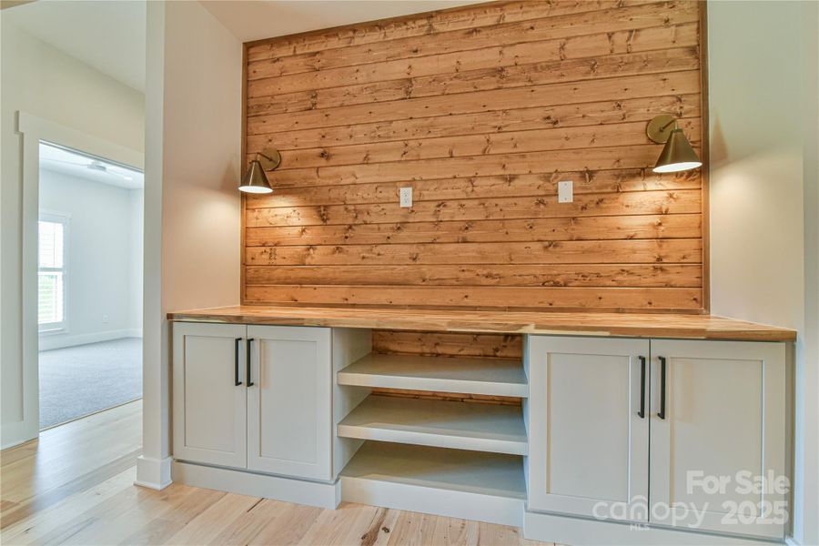 Built in cabinets with a tongue and grove accent wall. Similar photo.