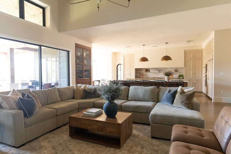 Living room featuring wood finished floors and a chandelier