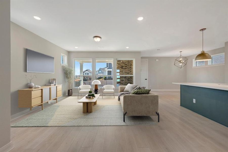 Living area featuring light wood finished floors and hanging lights