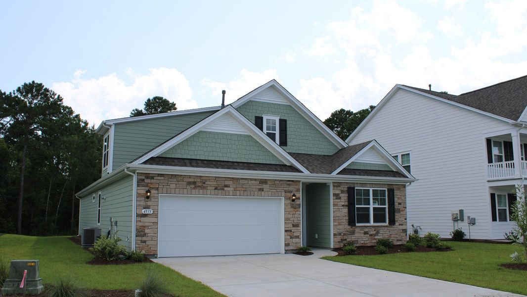 Front exterior of a new home in The Preserve at Shaftesbury Glen, Conway, SC, highlighting curb appeal (Image 2).