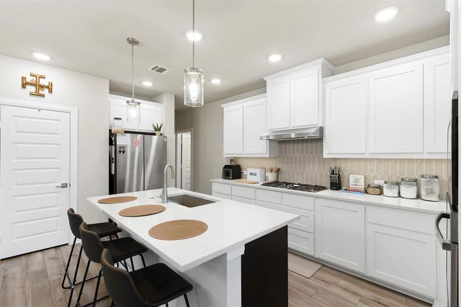 White cabinets and counter tops create a bright kitchen White cabinets and counter tops create a bright kitchen