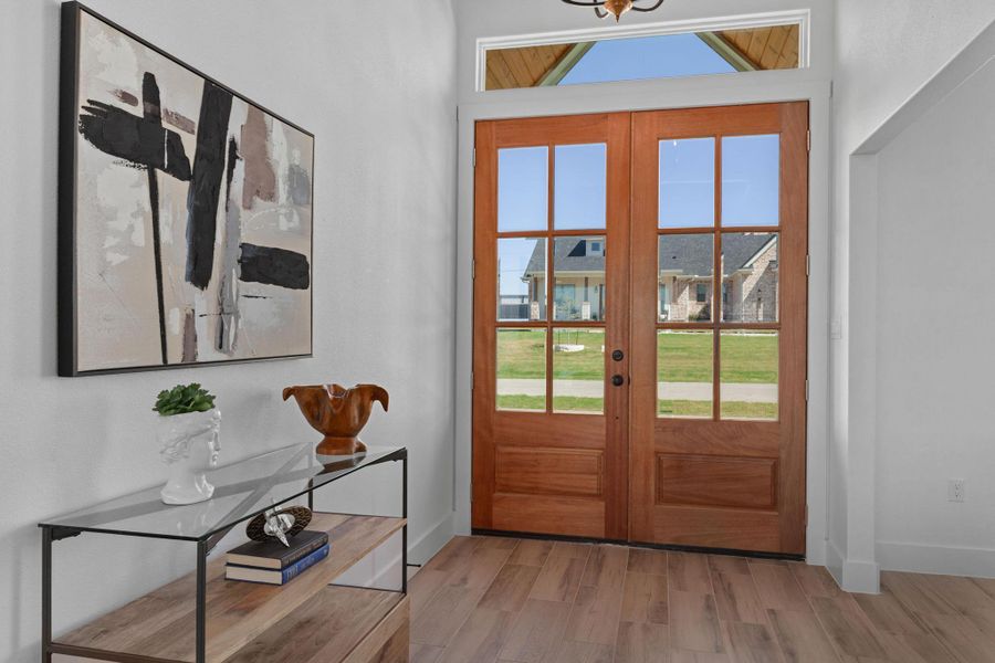 Doorway to outside with wood finished floors and french doors Doorway to outside with wood finished floors and french doors