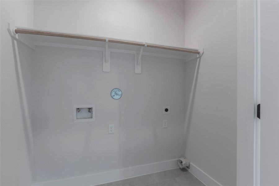 A spacious utility closet located off the flex space, offering ample storage for household essentials and a dedicated washer and dryer area for added convenience. A spacious utility closet located off the flex space, offering ample storage for household essentials and a dedicated washer and dryer area for added convenience.