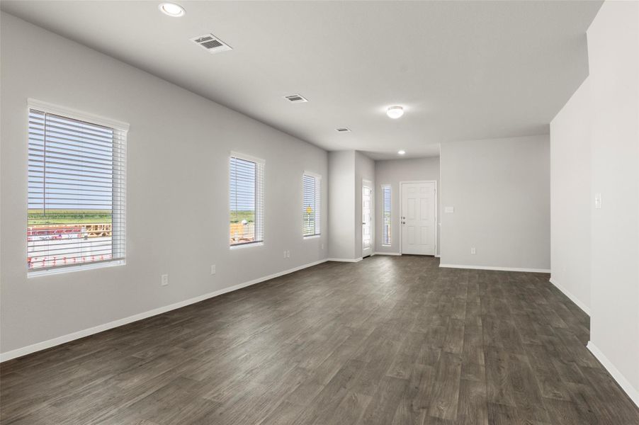 Spare room with dark wood-style flooring and recessed lighting