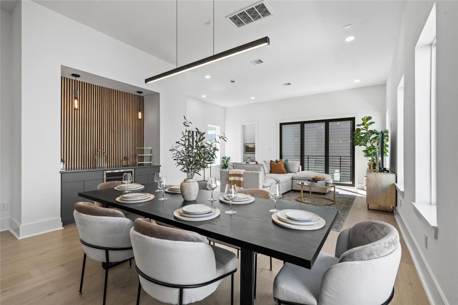 From intimate dinners to lively soirées, this open-concept space adapts with grace. Anchored by a custom dry bar and defined by a palette of soft neutrals and warm wood, the dining and living areas flow effortlessly into one another—culminating in floor-to-ceiling sliding doors that invite natural light and outdoor connection. It's a layout that supports the pace of modern living without ever feeling rushed. From intimate dinners to lively soirées, this open-concept space adapts with grace. Anchored by a custom dry bar and defined by a palette of soft neutrals and warm wood, the dining and living areas flow effortlessly into one another—culminating in floor-to-ceiling sliding doors that invite natural light and outdoor connection. It's a layout that supports the pace of modern living without ever feeling rushed.