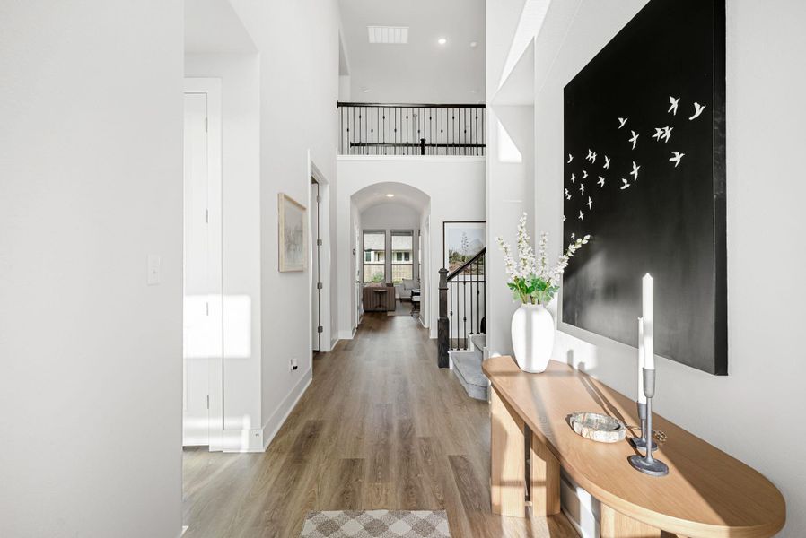 A spacious foyer welcomes you with high ceilings, warm flooring, and abundant natural light.