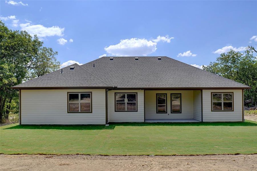 Back of house with a yard