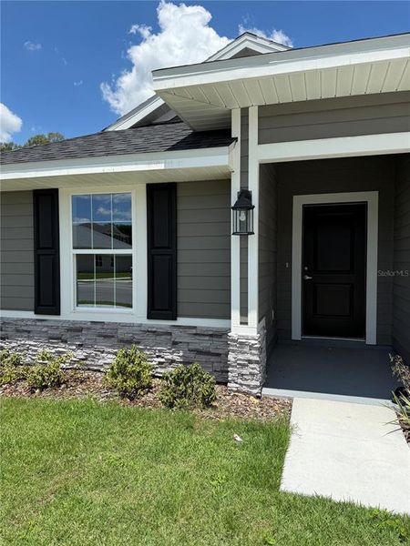 Front exterior of a new home in Savannah Station, Alachua, FL, highlighting curb appeal (Image 2).