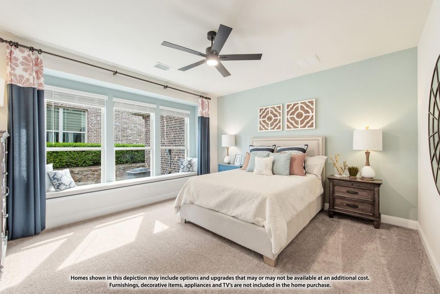 Bedroom with ceiling fan, large window, carpet flooring, and upholstered bed with nightstand