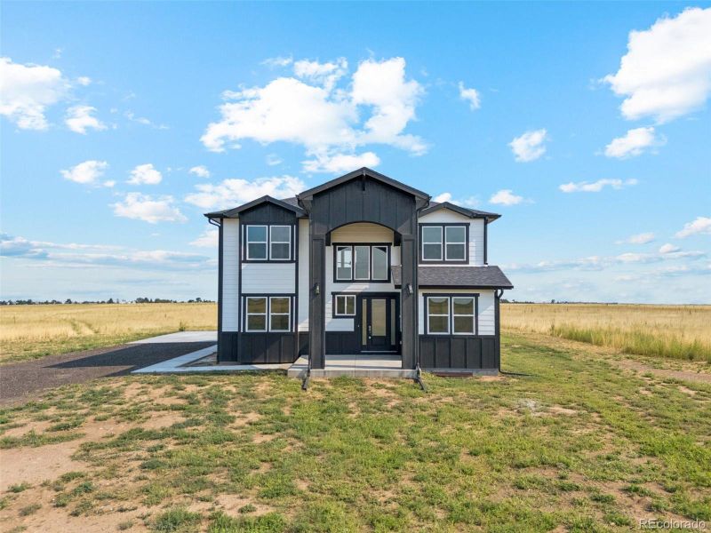 Front exterior of a new home in , Bennett, CO, highlighting curb appeal (Image 24).