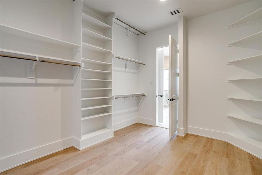 Walk in closet featuring light wood-style floors and visible vents