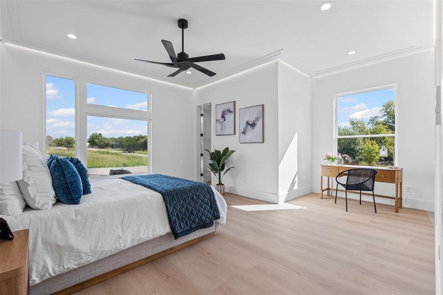 Bedroom with wood finished floors, a ceiling fan, recessed lighting, and crown molding