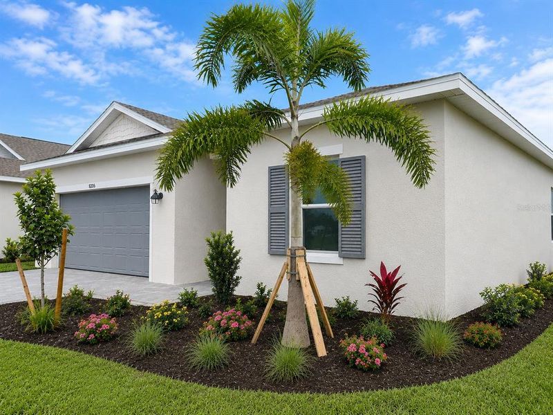Front exterior of a new home in Island Lakes at Coco Bay, Englewood, FL, highlighting curb appeal (Image 2).