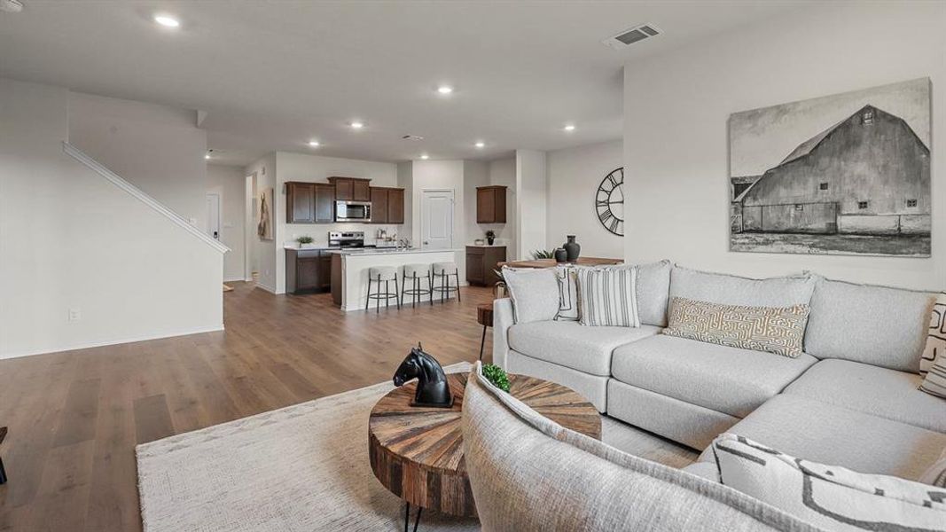Living room featuring wood finished floors and recessed lighting