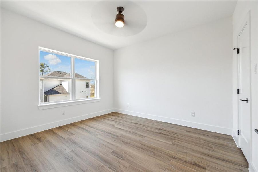 One of two secondary bedrooms on the 3rd level with walk-in closet, jack and jill en-suite bathroom.  Window coverings (not shown) have been installed as an added bonus!