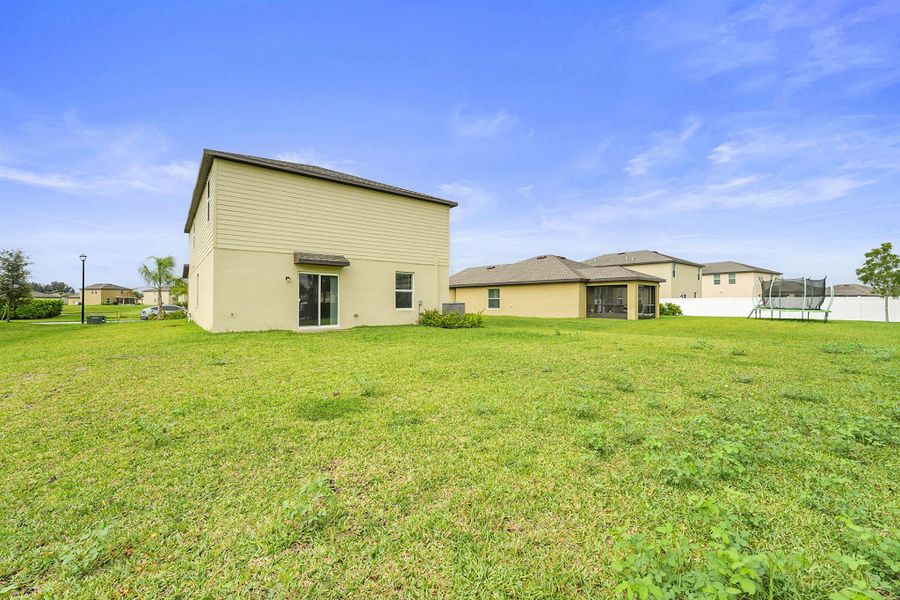 Front exterior of a new home in Bent Creek: The Meadows Collection, Fort Pierce, FL, highlighting curb appeal (Image 14).