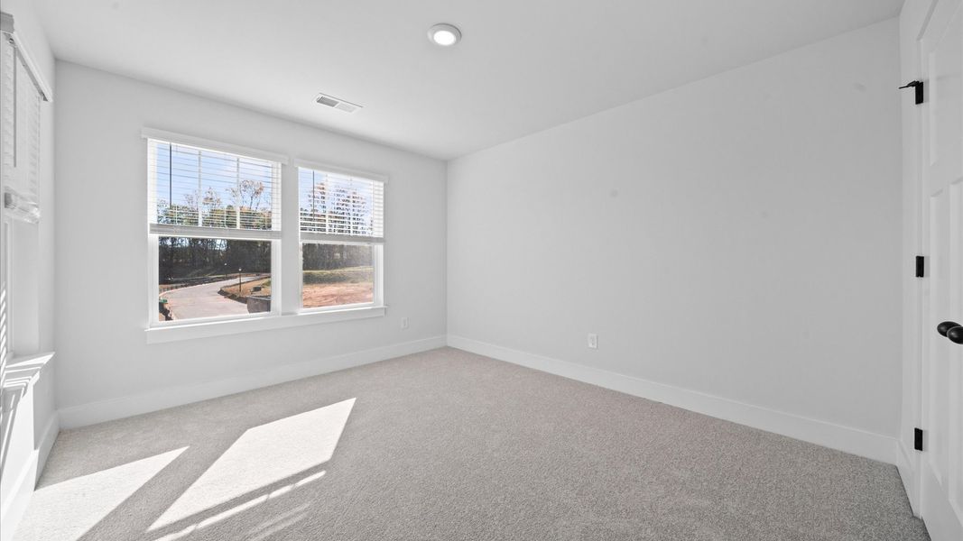 First-rate bedroom with plush carpeting and large windows that provide an open, airy feel