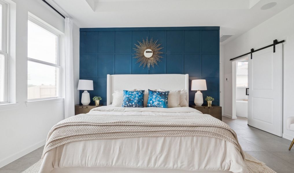 Primary suite with sliding barn door to private bath