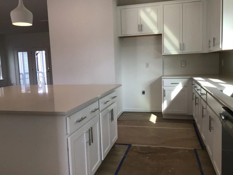 Kitchen featuring the AW Collection® Coastal - White cabinets and sea-glass tile backsplash.