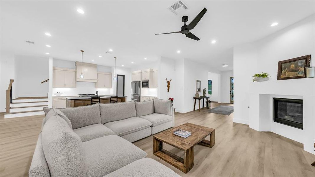 Living room featuring light wood-type flooring, recessed lighting, baseboards, and ceiling fan Living room featuring light wood-type flooring, recessed lighting, baseboards, and ceiling fan