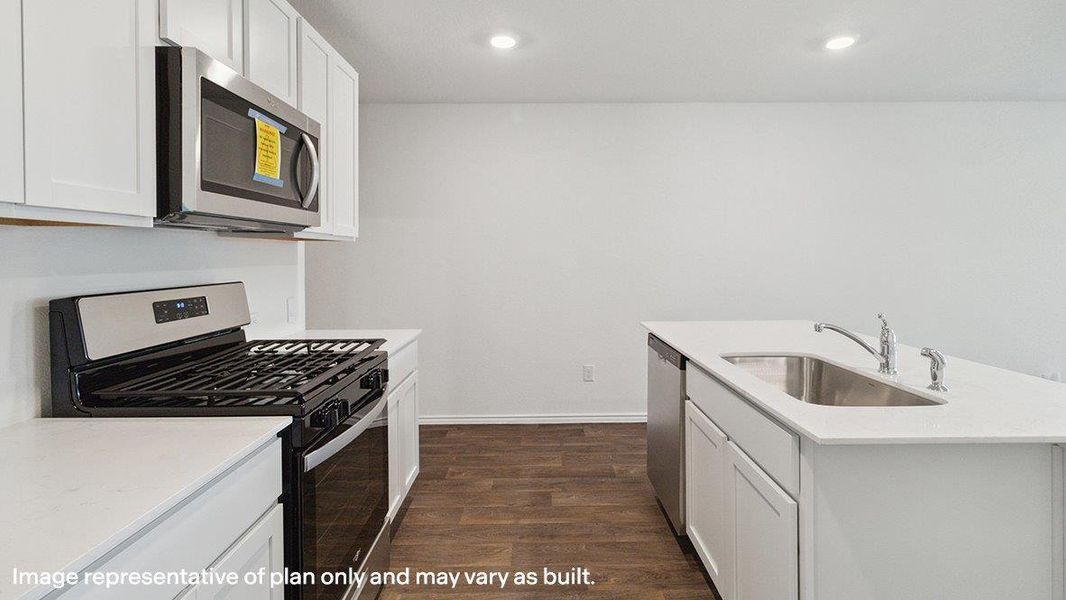 A well-appointed kitchen features a gas range, microwave, and dishwasher, alongside recessed lighting. A well-appointed kitchen features a gas range, microwave, and dishwasher, alongside recessed lighting.