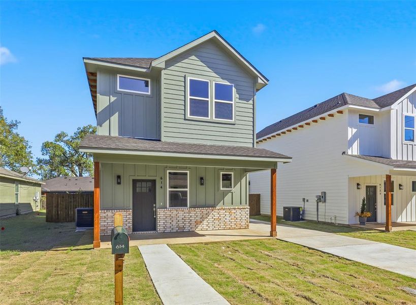 Front exterior of a new home in , Cleburne, TX, highlighting curb appeal (Image 1).