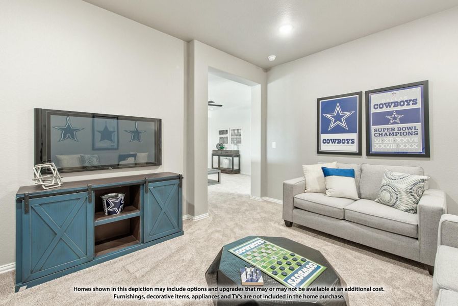 Living room with gray sofa, wall-mounted TV, blue barn-door media console, and Dallas Cowboys wall art