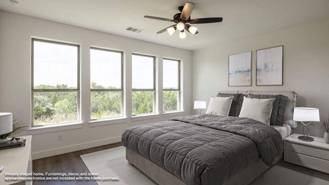 Bedroom featuring dark wood-style flooring and a ceiling fan Bedroom featuring dark wood-style flooring and a ceiling fan